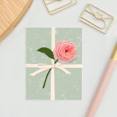 a card with a pink rose on it