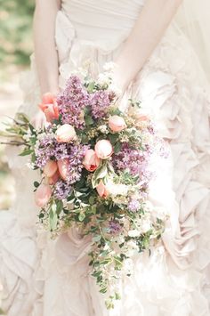 a bride holding a bouquet of flowers in her hand