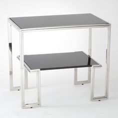 a black table with two silver legs and a glass shelf on the bottom that has one end