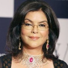 a woman wearing glasses and a necklace