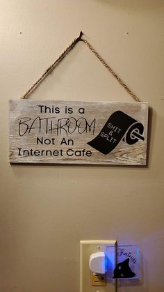 this is a bathroom not an internet cafe sign hanging on the wall next to a light switch