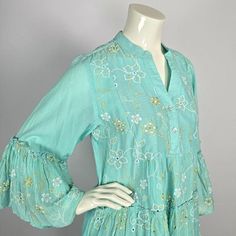 This stylish tunic is an ideal addition to any summer outfit.  Crafted from 100% lightweight cotton, the garment has a trendy light turquoise/aqua color and features flower-like embroidery.  The tunic has 3/4 sleeves, which end in embroidered, flared cuffs. This tunic has a universal fit, similar to a European size Medium to Large. Before ordering, please check the size of the tunic with your personal sizes. Size: about European size Medium to Large - all measurements are approx. shoulder width: Stylish Tunic, Embroidered Tunic, Light Turquoise, Aqua Color, Womens Tunics, Flared Sleeves, Tunic Dress, Womens Clothing Tops, Netherlands