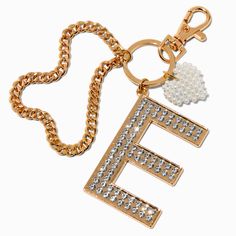 the letter e is attached to a gold keychain with white pearls on it