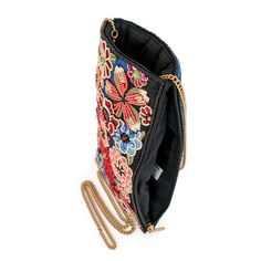 A modern beaded & embroidered floral pattern dances across a field of rich blue embroidery on this fashion-forward crossbody phone bag. 5 x 0.5 x 8" Strap Length End to End: 51" Strap Drop: 24" Removable crossbody chain strap Top compartment Side zipper compartment Fits a phone Includes metal logo fob This is a handmade item, each one an individual work of art. Slight variations may occur. Learn More about our Global Impact Embroidered Clutch Shoulder Bag For Travel, Embroidered Multicolor Evening Shoulder Bag, Evening Embroidered Multicolor Shoulder Bag, Evening Rectangular Shoulder Bag With Multicolor Embroidery, Embroidered Crossbody Evening Bag, Embroidered Evening Crossbody Bag, Evening Embroidered Crossbody Bag, Multicolor Evening Bags With Floral Embroidery, Beaded Crossbody Clutch