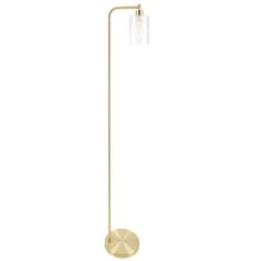 a brass floor lamp with a glass shade on the side and a round light fixture