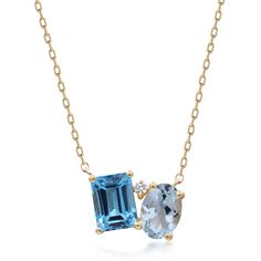 This blue topaz and diamond accent pendant necklace makes a stylish statement with luminous gemstones in an alluring modern design. Crafted in glistening 10K yellow gold, this pendant features one emerald cut blue topaz artistically set alongside one oval blue topaz in eye-catching shades of blue, complemented by an accent diamond. | Blue Topaz and Diamond Accent Pendant Necklace | 10K Yellow Gold | Size 18" | Helzberg Diamonds Diamond And Opal Necklace, Modern Gemstone Jewelry, Dainty Sapphire Necklace, Simple Stone Necklace, White Topaz Necklace, Emerald Necklace Pendant, Gem Pendant, Blue Pendant Necklace, Blue Topaz Jewelry