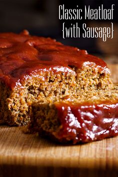 a loaf of meatloaf with sauce on a cutting board