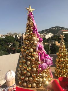 a decorated christmas tree sitting on top of a roof