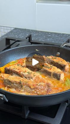 a pan filled with food on top of a stove