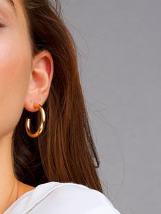 "Your new favorite thick hoops, these hoops are the perfect size. Thick and bold, surely to make the perfect statement. At a medium size these simple gold hoops can be for everyday or special occasions. DETAILS: All hoops are sold in pairs. Open Medium Diameter: 32mm Width: 4mm Open Classic Hoops Diameter: 44.5mm Width: 4mm QUALITY: * 100% 14k Gold Vermeil or Sterling Silver available What is 14k Gold Vermeil? We thought you would ask! :) 14k Gold Vermeil (pronounced \"ver-may\"), should not be Gold Earrings Big, Simple Gold Hoops, Catherine Paiz, Red Earrings Stud, Weave Ponytail, 14k Gold Hoop Earrings, Front Back Earrings, Earrings Big, Spiral Earrings