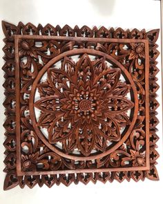 an intricately carved wooden wall hanging