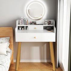 a white vanity with makeup and cosmetics on it next to a bed in a room