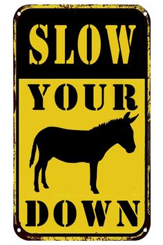 a sign that says slow your down with a donkey on it and the words slow your down below