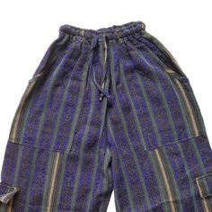 Nice comfy pants for going to the beach, camping, or spending the day at home.These hippie pants have 2 pockets on the front + 2 cargo pockets +1 pocket on the back.They are high-waisted boho pants. They have a drawstring in the waist. It was handmade by Ecuadorian artisans using the foot-treadle loom technique.Materials:75% cotton and 25% acrylic Measurements:Waist circumference: stretches from 24" up to 34"Hip circumference: 42"Rise: 11"Inseam: 28"Total Length: 39"Thigh: 12"Leg opening: 8" Car Beach Harem Bottoms With Pockets, Bohemian Long Pants With Side Pockets, Bohemian Harem Pants With Pockets For Vacation, Bohemian Bottoms With Pockets For Vacation, Baggy Harem Pants With Pockets For Vacation, Harem Pants With Pockets For Beach, Blue Relaxed Fit Hippie Bottoms, Blue Hippie Relaxed Fit Bottoms, Blue Hippie Harem Pants With Pockets