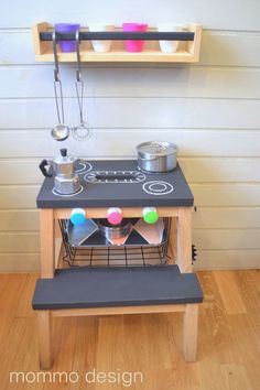 a toy stove with pots and pans on it