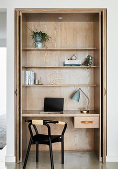 an open bookcase with a desk and chair