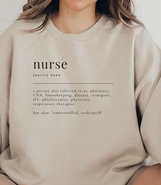 a woman wearing a sweatshirt with the words nurse printed on it