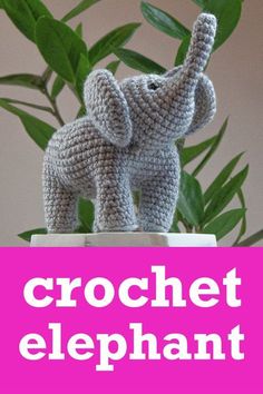 a crochet elephant sitting on top of a plant