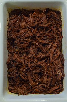 a square white dish filled with chocolate cake