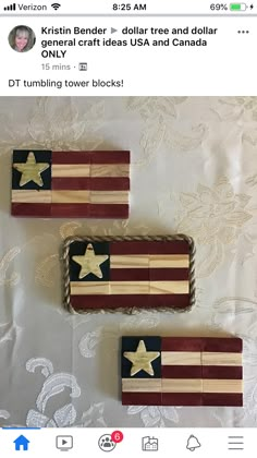 two wooden blocks with stars on them sitting on a white cloth covered tablecloth, next to each other