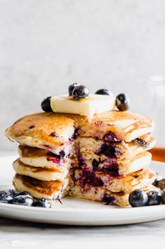 a stack of pancakes with blueberries and bananas