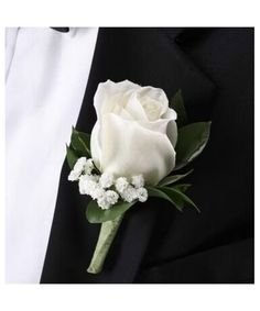 a white rose and baby's breath boutonniere on a black suit