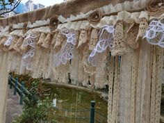 lace and burlock are hung on the side of a bridge