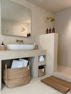 a bathroom with a sink, mirror and towel rack on the wall next to it