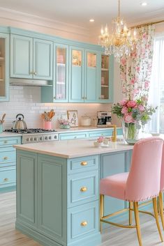 a kitchen with blue cabinets, pink chairs and a chandelier hanging from the ceiling