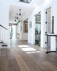 an empty house with wood floors and white walls