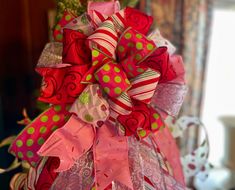 a pink and green bow with polka dots on it