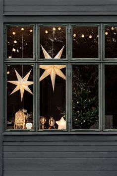 christmas decorations are displayed in the window of a house