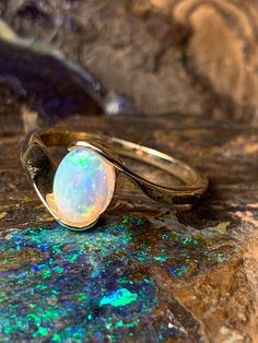 🔥 DESCRIPTION Handcrafted to deliver results of unsurpassed quality, this ring will serve as a lasting memory and a connection to the one you love. In addition to its minimalist style, the brilliant opal at its center makes this ring look beyond comparison, drawing attention from every angle. Finished with a smooth fine gold frame, this ring will certainly fit your style.  Key Features:  ●Colourful Oval Shape Australian Crystal Opal ●Oval Ring ●9 Karat Gold  ●Fast Shipping ●Limited Availability  Specifications:  ●Total Weight: 1.95g ●Opal size: 7x5mm Made with love all the way from Australia  P.S. All our ring can be resized, If you require a different ring size which is not on the list. please select the option at checkout or email me. I would be happy to accommodate your need.  🔥 W H Y White Open Ring With Tension Setting, Adjustable Opal Ring For Anniversary, Adjustable White Gold Opal Ring For Anniversary, Adjustable 14k Gold Opal Ring For Anniversary, Classic Adjustable Opal Ring For Anniversary, Classic Round Cut Opal Birthstone Ring, Solitaire Open Band Jewelry For Anniversary, Adjustable Yellow Gold Opal Ring For Anniversary, Adjustable Fine Jewelry Opal Ring For Anniversary