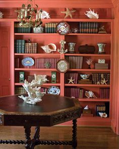 a table in front of a book shelf filled with books