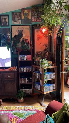 a living room filled with furniture and lots of plants