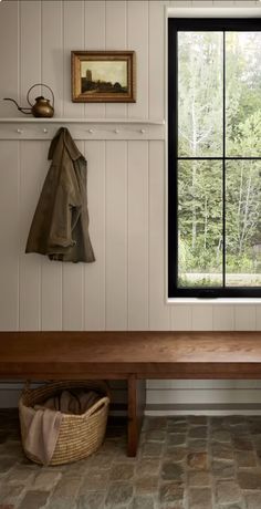 a wooden bench sitting next to a window