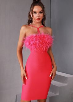 a woman in a pink dress posing for the camera