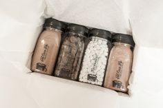 five spice jars in a white paper bag