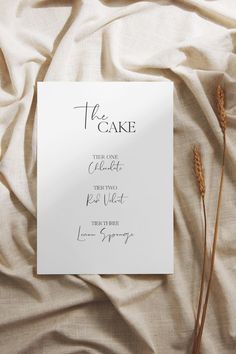 a piece of paper with the words he cake on it next to some dry grass