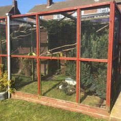 an outdoor area with a fence and some plants