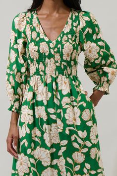 A season favorite list has to include the Lucena Floral Lemy Poplin Midi Dress. It features long sleeves, smocked bodice, and a v-neckline. The bottom has a ruffle hem tier. Wear it with matching ivory heels to create a full look. - Smocked- Deep V-neck- Floral- Lined- Color: Green MultiSize + Fit - Model is 5'10" and wearing size XS- Measurements taken from size S - Chest: 15 1/4"- Length: 49 3/4" Fabric Self: 100% Cotton, Lining: 97% Polyester 3% Spandex Style Number STD14589P Playful Green Floral Print Dress, Casual Green Floral Print V-neck Dress, Green Floral Print V-neck Summer Dress, Green Floral Print Midi V-neck Dress, Ivory Heels, Spring Paisley Print V-neck Midi Dress, Full Look, Green Midi Dress, Tiered Maxi Dress