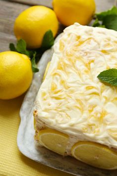 a cake with lemons and mint on the side