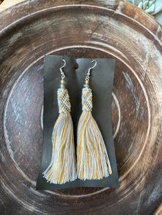 "BEADED TASSEL DROP EARRINGS ** IN STOCK & READY TO SHIP** These hand-assembled earrings are quite the beauty! They each feature beaded detailing with a multi-color tassel. We personally source and hand-pick our products directly from the craftspeople and families of Bali and other Indonesian Islands to ensure that you receive authentic and high-quality pieces. Our products are made traditionally by the locals of Indonesia using their craftmanship skills passed down for generations. Our miss Traditional Beaded Tassel Earrings, Traditional Adjustable Beaded Tassel Earrings, Yellow Tassel Earrings For Festival, Adjustable Handwoven Dangle Tassel Earrings, Adjustable Yellow Bohemian Tassel Earrings, Yellow Bohemian Adjustable Tassel Earrings, Bohemian Yellow Adjustable Tassel Earrings, Yellow Bohemian Tassel Earrings, Adjustable Beaded Earrings With Tassels As Gift