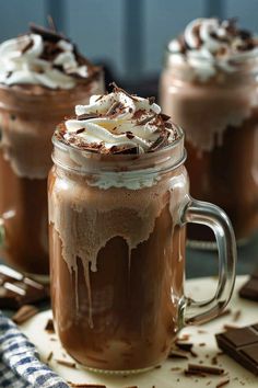 two mugs filled with hot chocolate and whipped cream