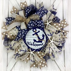 a blue and white wreath with an anchor on it