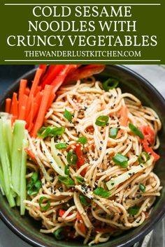 a bowl filled with noodles, carrots and celery on top of a table