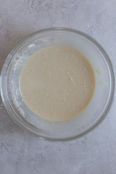 a glass bowl filled with liquid on top of a table