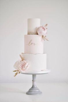 a three tiered wedding cake with flowers on top and the words instagram above it