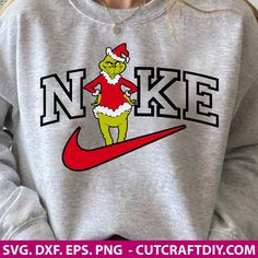 the grinch is wearing a santa hat and running on a nike sweatshirt