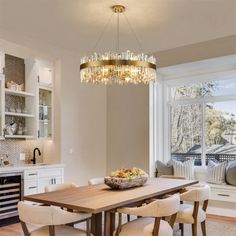 a dining room table and chairs in front of a window